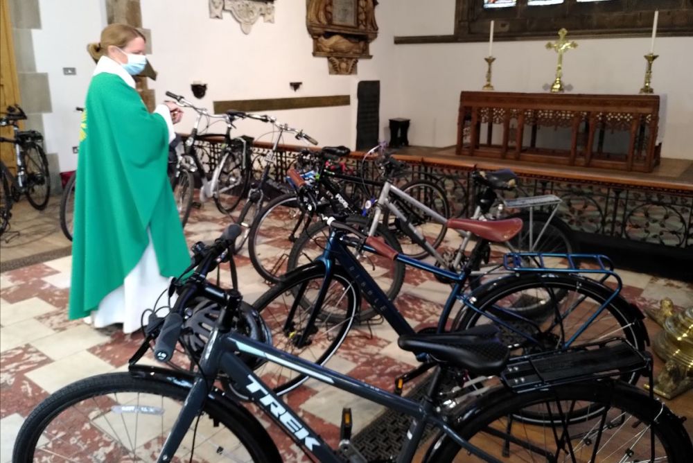 revd Emily blessing a number of bicycles