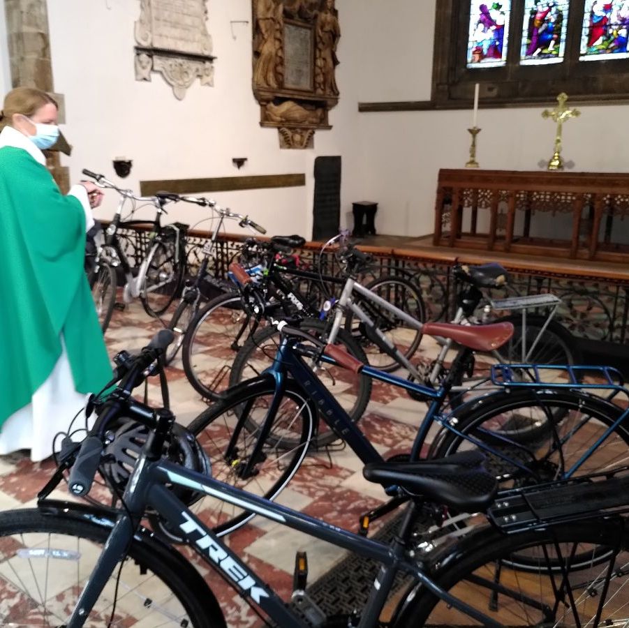 revd Emily blessing a number of bicycles