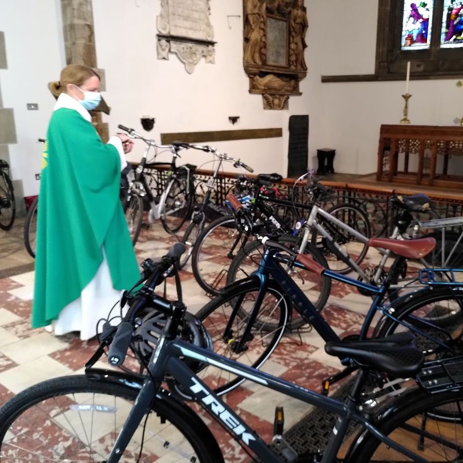 revd Emily blessing a number of bicycles