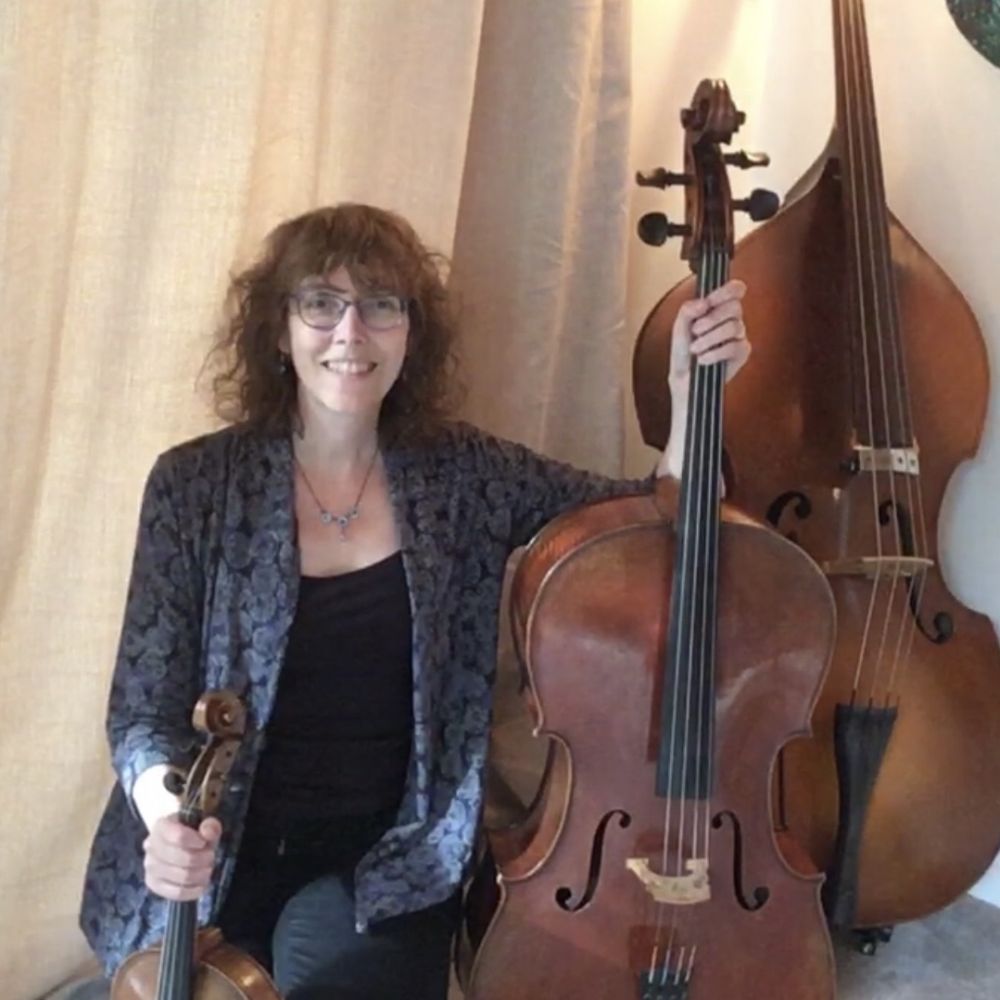 A picture of Kate Burns with violin, cello and double bass