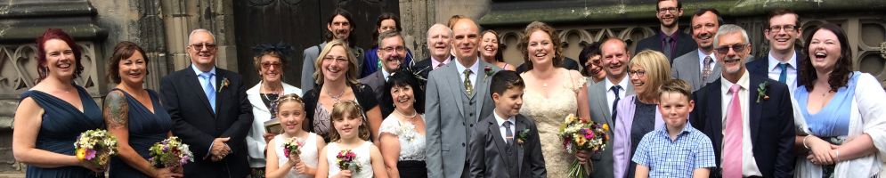 A large group of people outside the church on a wedding day