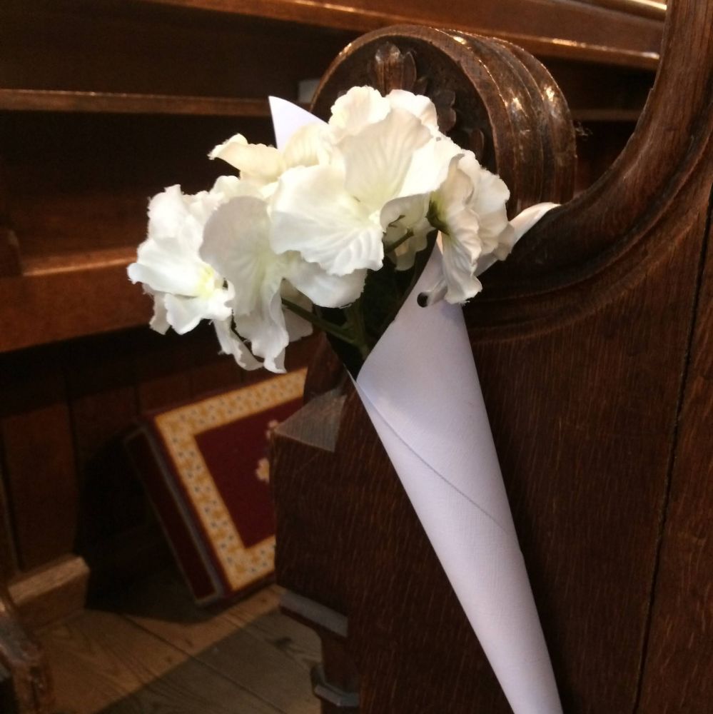 Pew end decoration of white flowers
